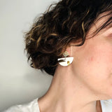boucles d'oreilles blanches et dorées au design graphique 